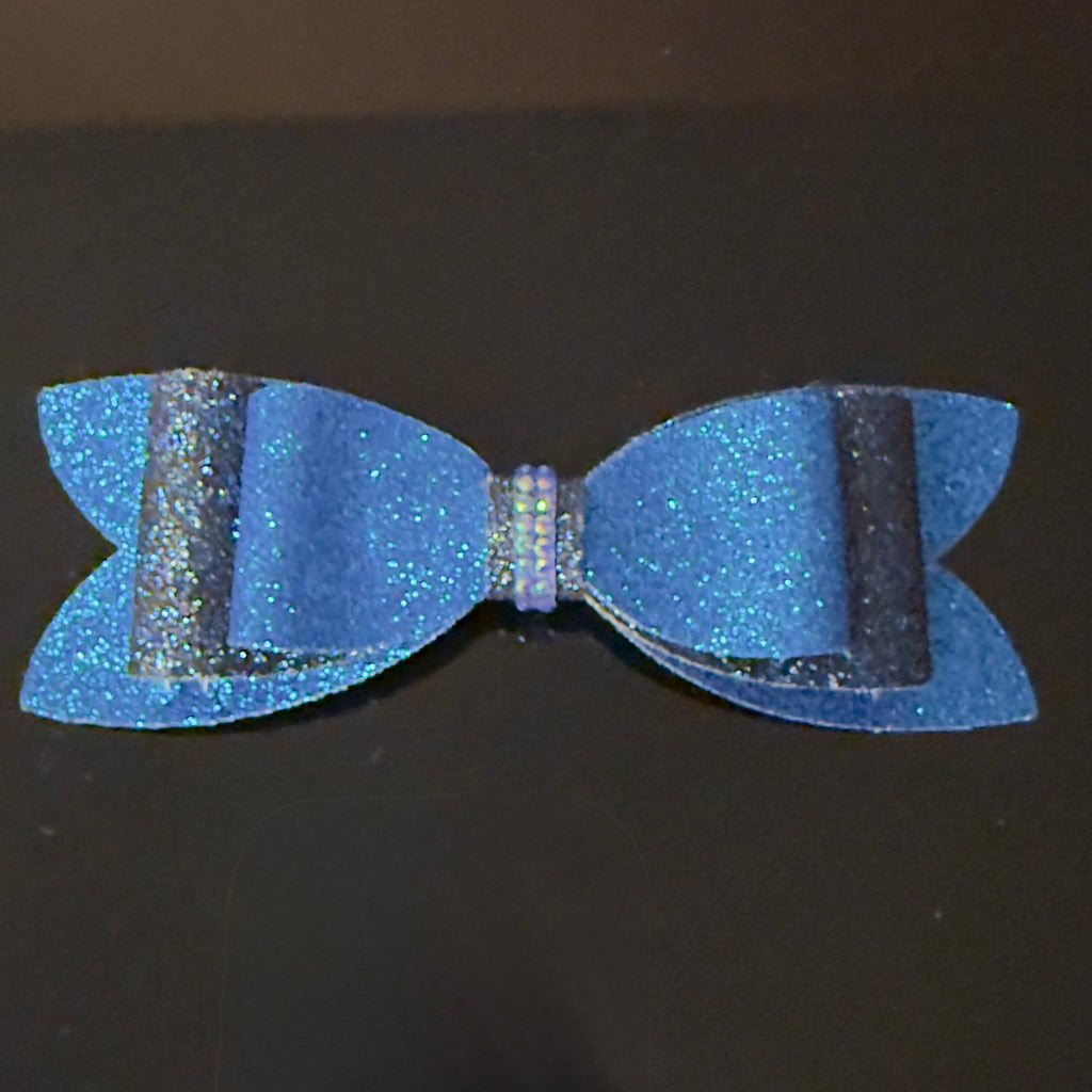 Blue glittery bow on a black background