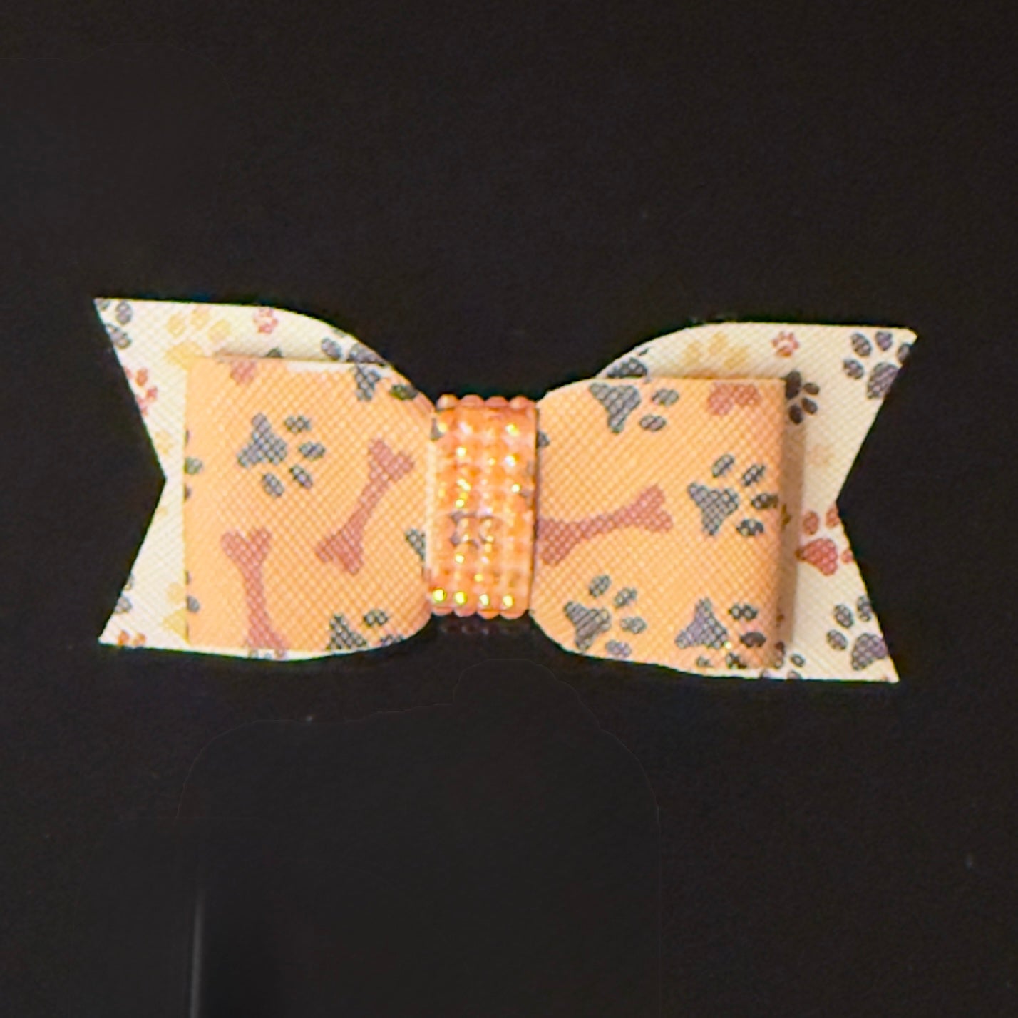 Dog bow tie with bone pattern on a black background