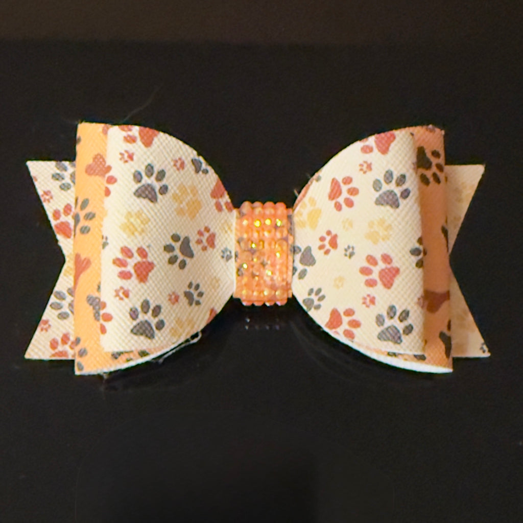Bow with paw print pattern on a dark background