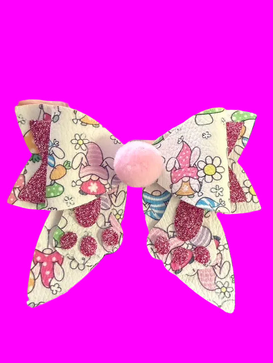 Colorful decorative bows held by a hand with a blurred background