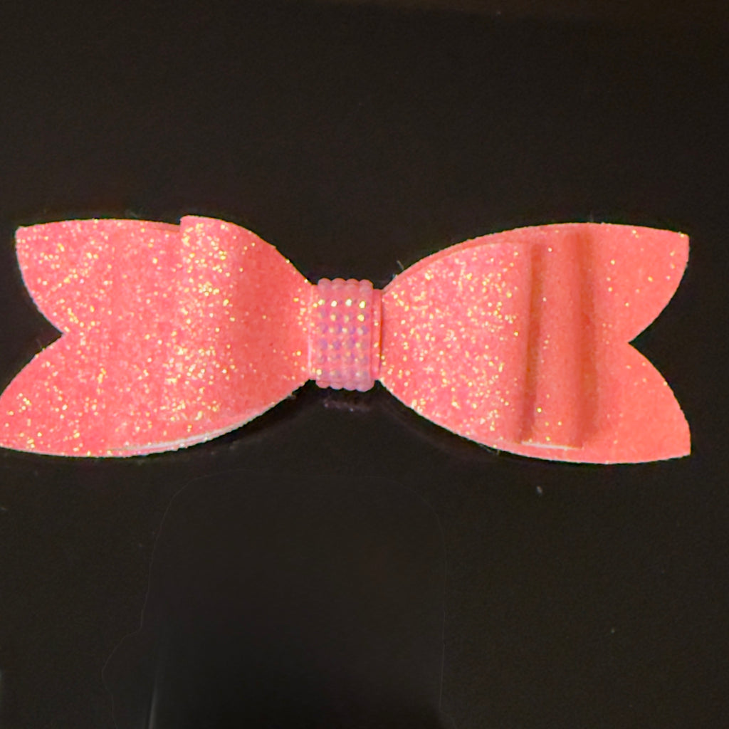 Pink glittery bow on a black background