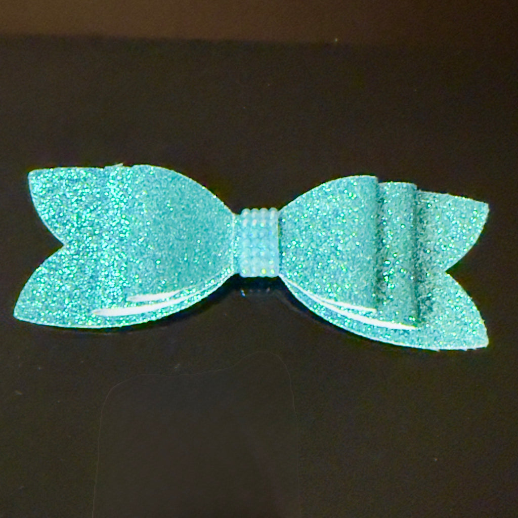 Turquoise glittery bow on a black background